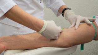 Phlebotomist working with patient