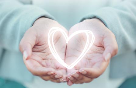 A drawing of a heart in a person's upturned hands