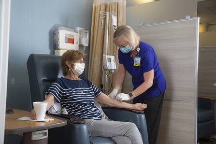 Michelle Miller, RN, Clinical Nurse Supervisor, with patient in the infusion suite, part of hematology and oncology services.