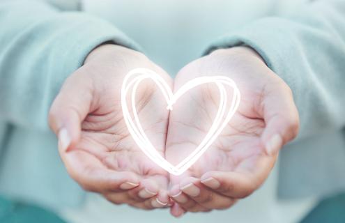 A drawing of a heart in a person's upturned hands