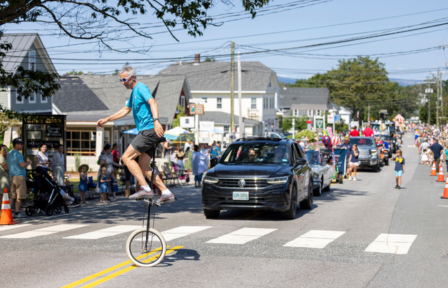 A person riding a unicycle on a road during Hospital Days.